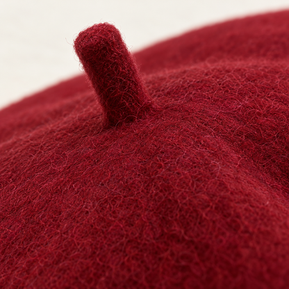 Macro detail of burgundy beret surface and matching center stem