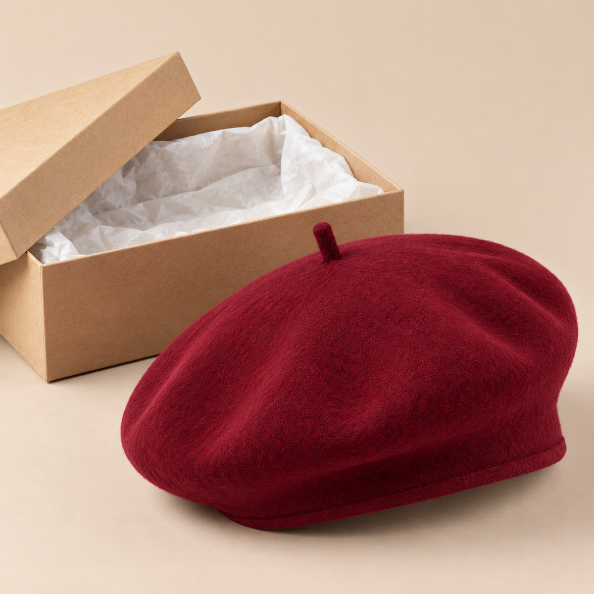 Burgundy beret beside unbranded kraft paper box
