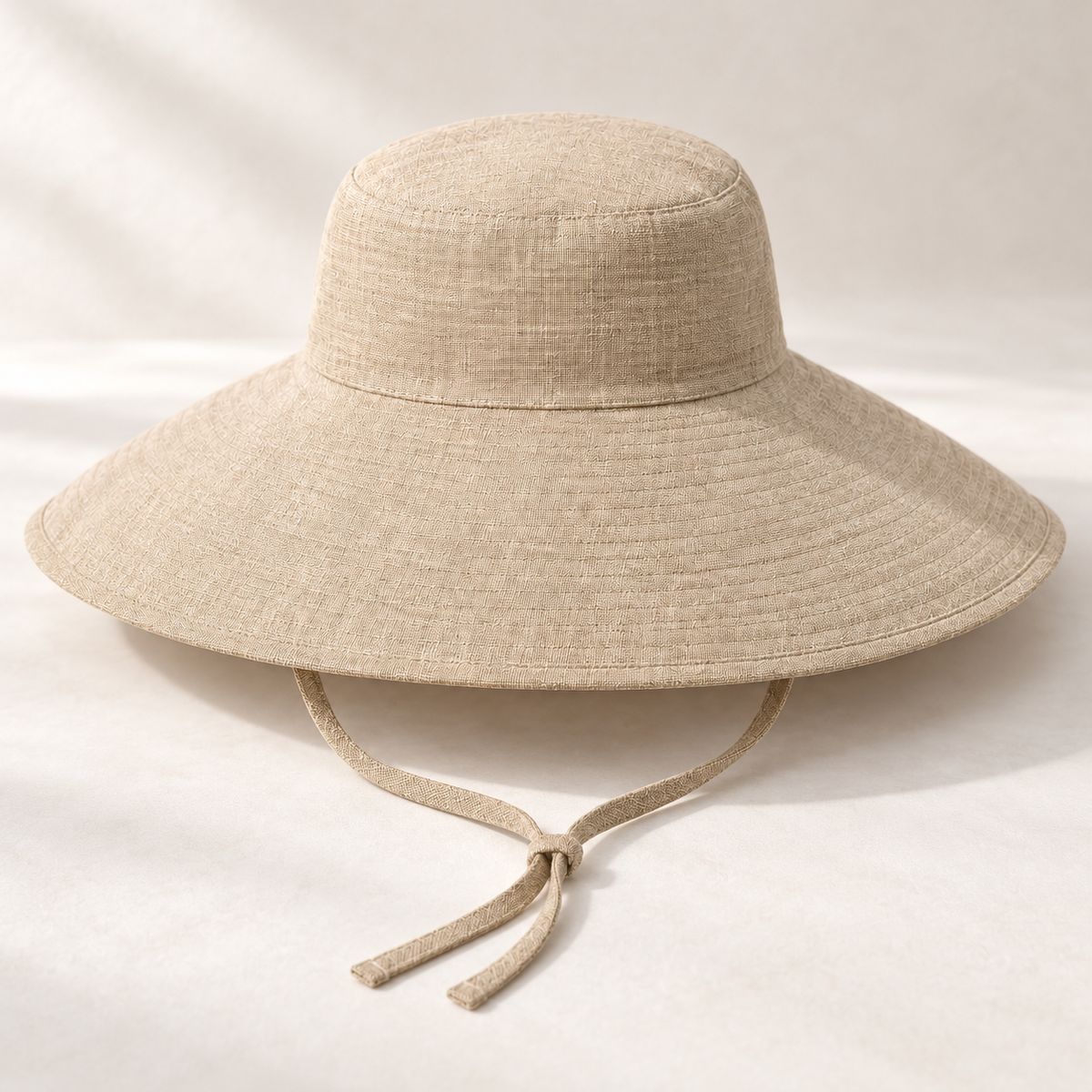 Sand Wide-Brim Tie Sun Hat — surface texture (AI-generated design visualization)